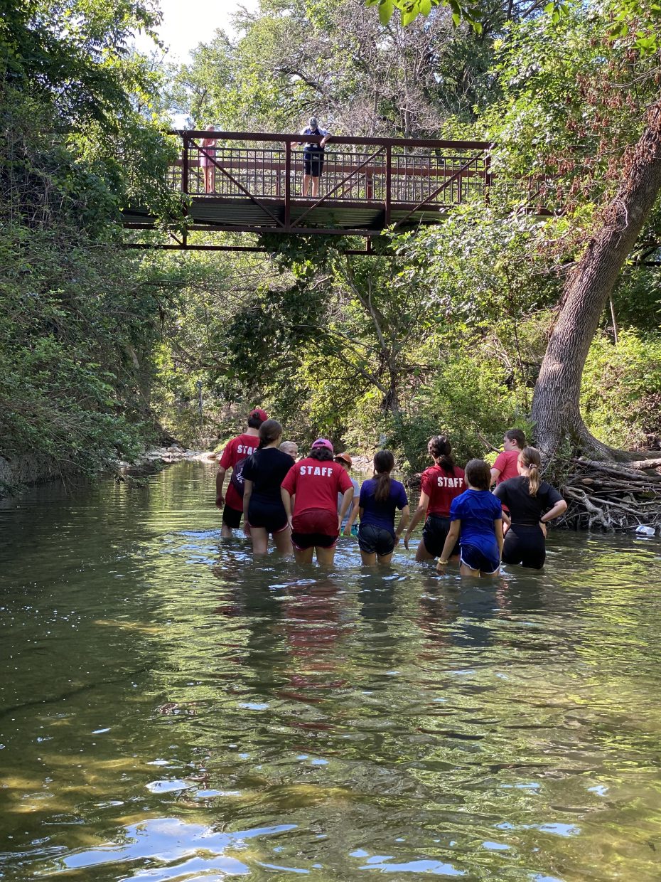 The Heritage Farmstead Museum's Summer Camp at the Creek. Photo of staff and children exploring the nearby creek.