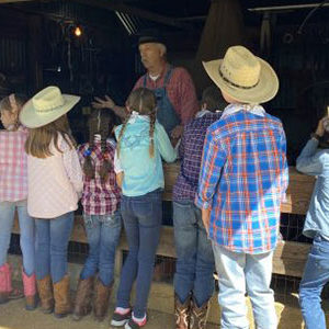 man showing a group of children life on the farm
