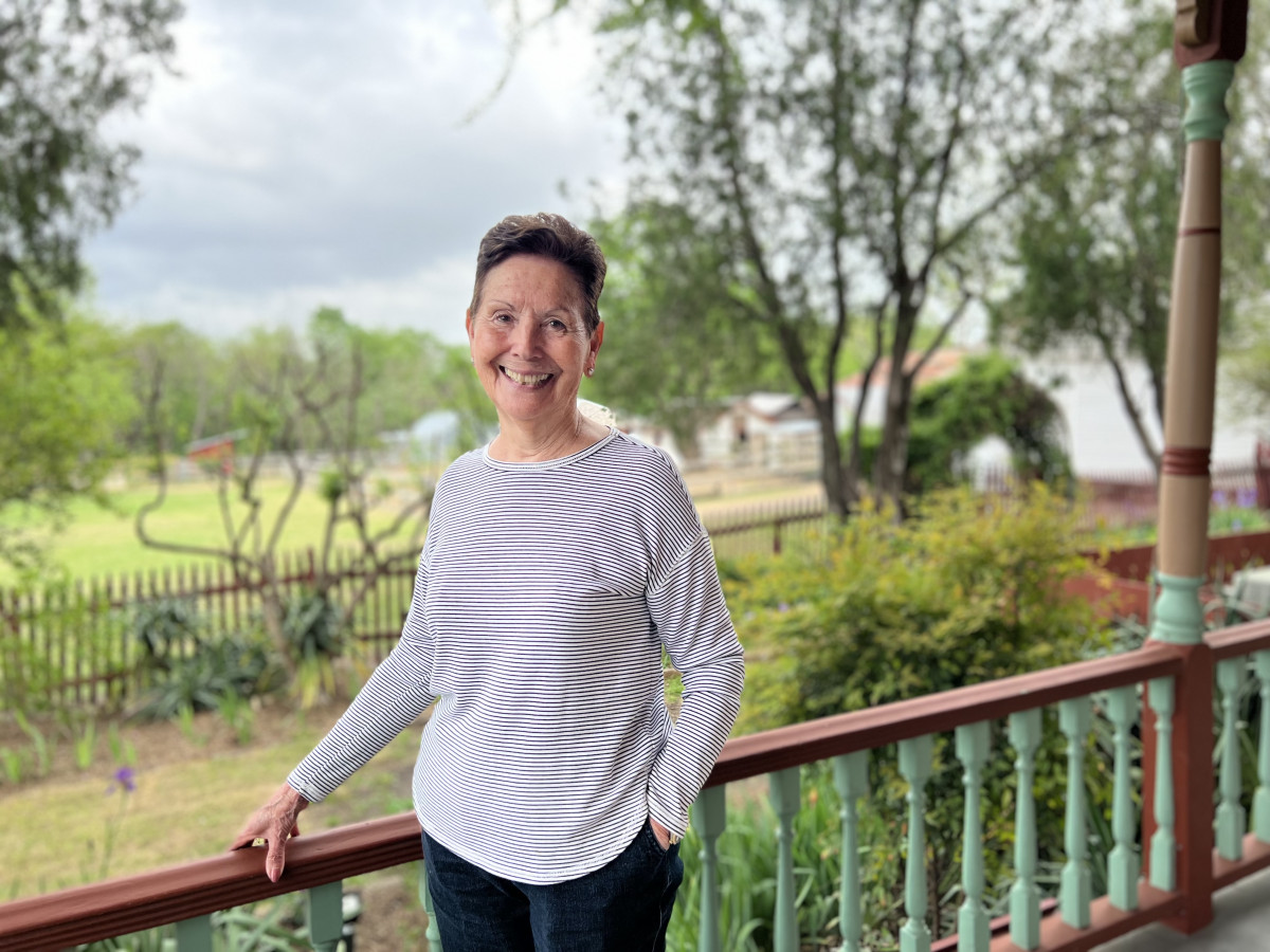 Woman at the Heritage Farmstead porch